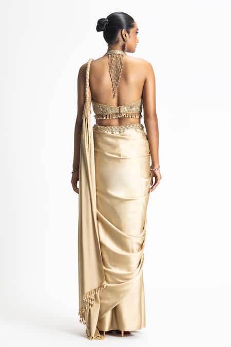 Shop Nitika Gujral Gold Satin, Organza Beads Halter Neck Pleated Pallu Pre-draped Saree With Blouse at Aza Fashions Shop_Nitika Gujral_Gold Satin, Organza Beads Halter Neck Pleated Pallu Pre-draped Saree With Blouse _at_Aza_Fashions