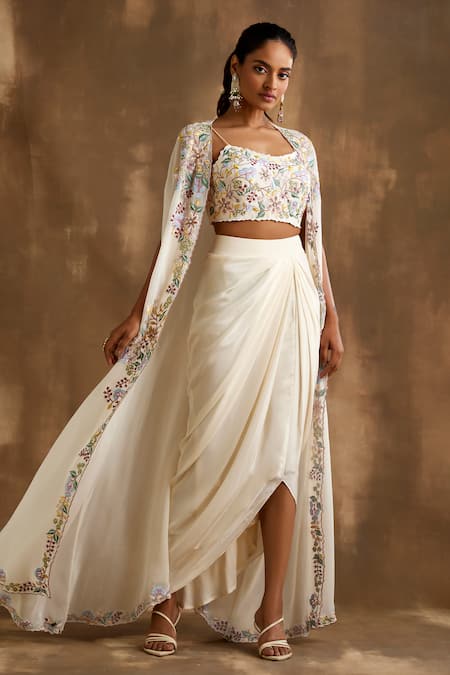 Niamh By Kriti Ivory Silk Embroidery, Cut Work Square Neck Floral Border Cape Draped Skirt Set Online at Aza Fashions Niamh By Kriti_Ivory Silk Embroidery, Cut Work Square Neck Floral Border Cape Draped Skirt Set _Online_at_Aza_Fashions