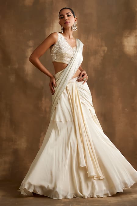 Buy Niamh By Kriti Ivory Silk, Crepe Sequins, Cut Work One Attached Draped Lehenga With Blouse Online at Aza Fashions Buy_Niamh By Kriti_Ivory Silk, Crepe Sequins, Cut Work One Attached Draped Lehenga With Blouse _Online_at_Aza_Fashions