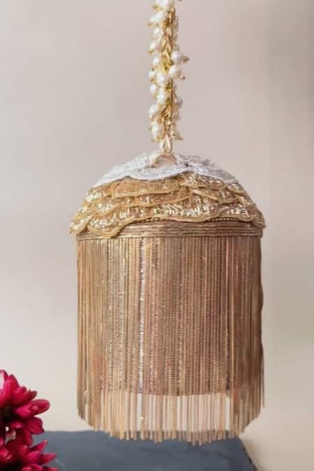Shop Nayaab By Sonia Gold Embroidery, Cut Work Hinted Cascade Luxe Tassel Embellished Potli at Aza Fashions Shop_Nayaab By Sonia_Gold Embroidery, Cut Work Hinted Cascade Luxe Tassel Embellished Potli _at_Aza_Fashions