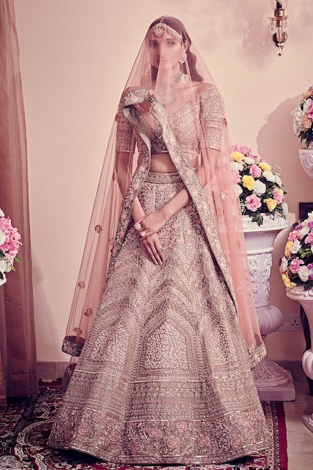 Bride wearing a pastel pink lehenga with a yellow dupatta and emerald  jewellery. | Pink bridal lehenga, Indian bride outfits, Indian wedding  dress designers