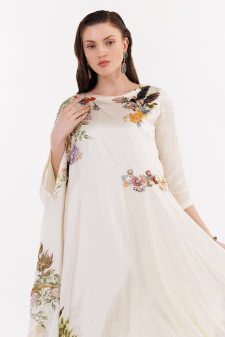 Shop Eeksha Ivory Satin Embroidery Boat Neck Floral Applique Embellished Asymmetric Kaftan at Aza Fashions Shop_Eeksha_Ivory Satin Embroidery Boat Neck Floral Applique Embellished Asymmetric Kaftan _at_Aza_Fashions