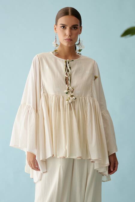 Nikasha_Cream Handloom Cotton Embroidery Round Neck Tasseled Asymmetric Blouse _Online_at_Aza_Fashions