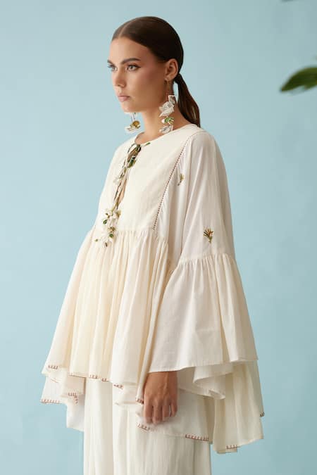 Buy_Nikasha_Cream Handloom Cotton Embroidery Round Neck Tasseled Asymmetric Blouse _Online_at_Aza_Fashions