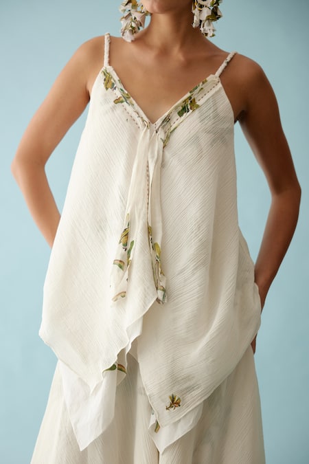 Shop Nikasha Off White Cotton Embroidery V-neck Asymmetrical Layered Top And Skirt Set Online at Aza Fashions Shop_Nikasha_Off White Cotton Embroidery V-neck Asymmetrical Layered Top And Skirt Set _Online_at_Aza_Fashions