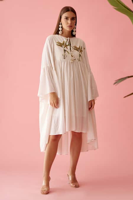 Nikasha_Cream Cotton Tassels V-neck Banana Tree Print Yoke Frill Dress _Online_at_Aza_Fashions