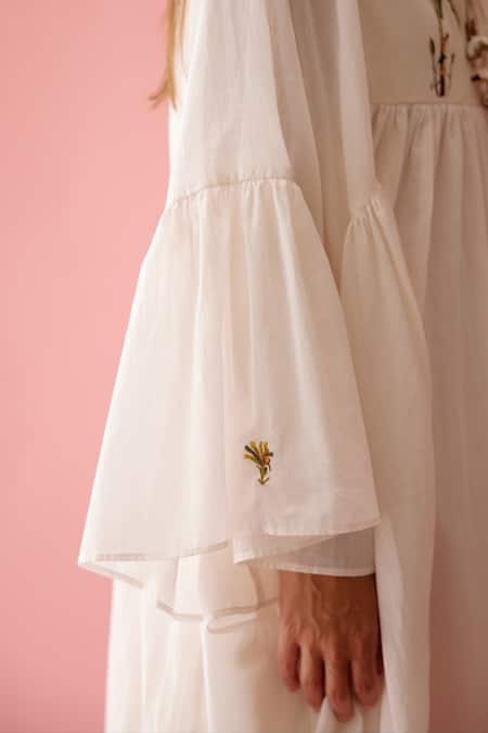 Nikasha_Cream Cotton Tassels V-neck Banana Tree Print Yoke Frill Dress _at_Aza_Fashions