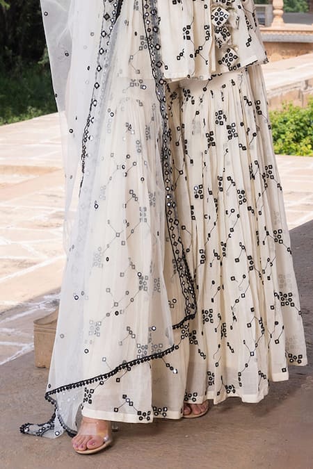 Preevin White Cotton, Net, Tulle Mirrors, Embroidery Floral Jaal Angarakha Sharara Set Online at Aza Fashions Preevin_White Cotton, Net, Tulle Mirrors, Embroidery Floral Jaal Angarakha Sharara Set _Online_at_Aza_Fashions