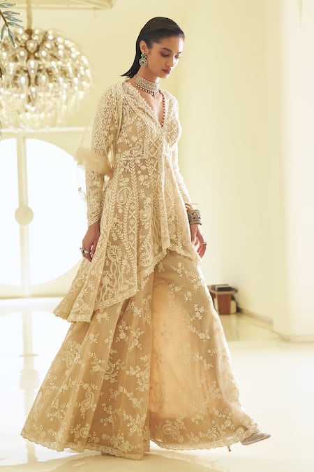 Seema Gujral_Beige Net Sequins, Pearls, Paisley Embroidered High-low Jacket Sharara Set _Online_at_Aza_Fashions