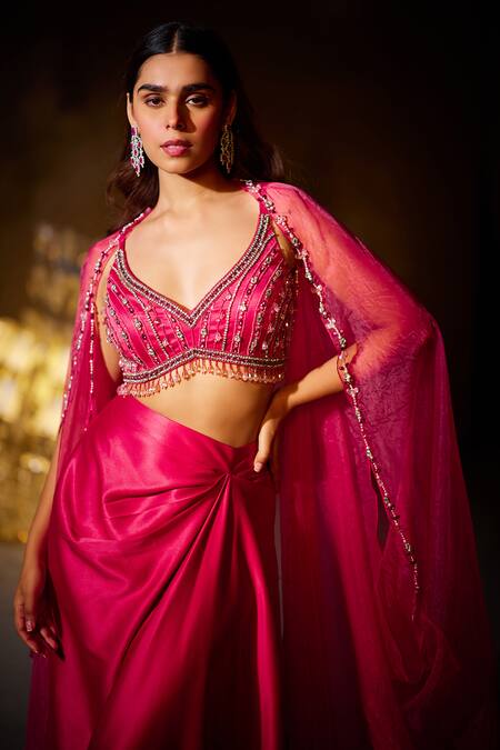 Shop Divya Aggarwal Fuchsia Heavy Satin Embellished Beads Leaf Neck Rose Border Cape Skirt Set Online at Aza Fashions Shop_Divya Aggarwal_Fuchsia Heavy Satin Embellished Beads Leaf Neck Rose Border Cape Skirt Set _Online_at_Aza_Fashions