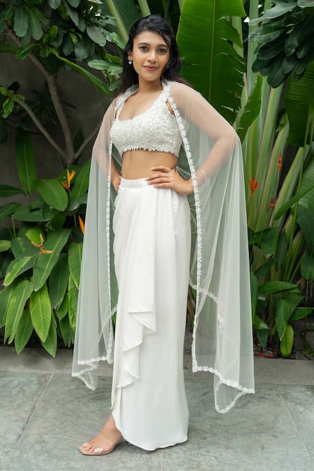 Shop Aakansha Gupta Ivory Silk, Net, Satin Embroidery Open Neck Dahlia Bloom Cape Draped Skirt Set at Aza Fashions Shop_Aakansha Gupta_Ivory Silk, Net, Satin Embroidery Open Neck Dahlia Bloom Cape Draped Skirt Set _at_Aza_Fashions