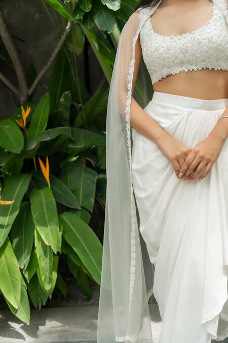 Shop Aakansha Gupta Ivory Silk, Net, Satin Embroidery Open Neck Dahlia Bloom Cape Draped Skirt Set Online at Aza Fashions Shop_Aakansha Gupta_Ivory Silk, Net, Satin Embroidery Open Neck Dahlia Bloom Cape Draped Skirt Set _Online_at_Aza_Fashions