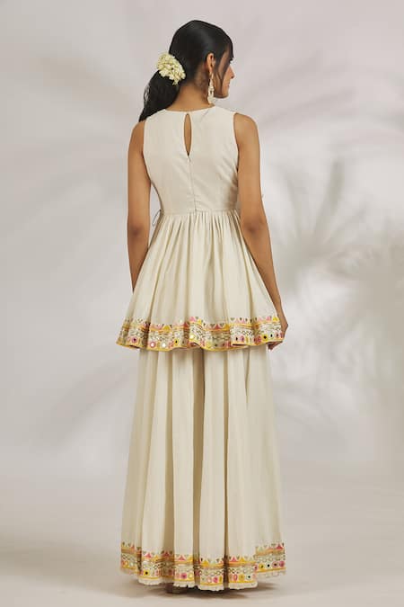 Shop Gopi Vaid Ivory Cotton Sequins, Mirrors Plunge Hana Embroidered Peplum Kurta With Sharara at Aza Fashions Shop_Gopi Vaid_Ivory Cotton Sequins, Mirrors Plunge Hana Embroidered Peplum Kurta With Sharara _at_Aza_Fashions