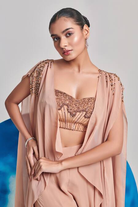 One Knot One By Ashna Beige Georgette Sequins, Cut Work Cutdana Tasselled Draped Cape Sharara Set at Aza Fashions One Knot One By Ashna_Beige Georgette Sequins, Cut Work Cutdana Tasselled Draped Cape Sharara Set _at_Aza_Fashions