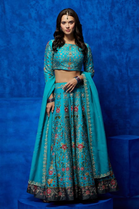 A blue velvet handcrafted lehenga with exaggerated floral embroidery teamed  with contrast tulle bustier and silk organza dupatta. . Kindl... | Instagram