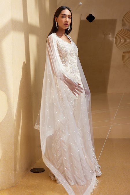 Istya_Ivory Net Beads, Sequins, Tassels Boat Neck Floral Embroidered Kurta Sharara Set _at_Aza_Fashions