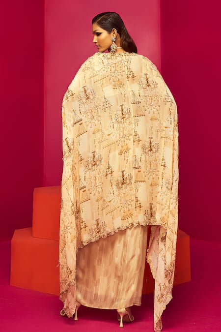 Shop Krisha Sunny Ramani Ivory Crepe, Georgette Sequins, Beads Chandelier Print Cape Dhoti Skirt Set at Aza Fashions Shop_Krisha Sunny Ramani_Ivory Crepe, Georgette Sequins, Beads Chandelier Print Cape Dhoti Skirt Set _at_Aza_Fashions