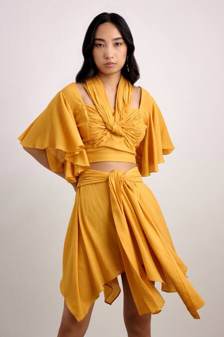 Buy Echostudio Yellow Linen, Crepe Halter Neck Knotted Draped Crop Top And Skirt Set Online at Aza Fashions Buy_Echostudio_Yellow Linen, Crepe Halter Neck Knotted Draped Crop Top And Skirt Set _Online_at_Aza_Fashions