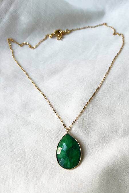 Free Photo | A green stone is on a gold necklace
