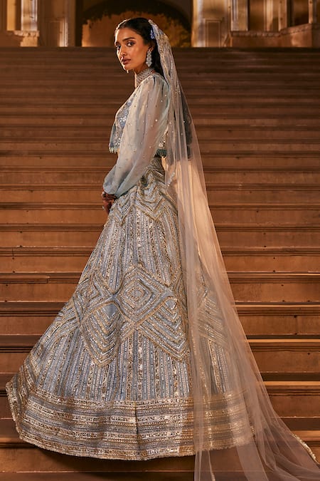 Shop The Royaleum Blue Silk, Net Crystals, Stones, Sequins, Tassels Round Embroidered Lehenga Set at Aza Fashions Shop_The Royaleum_Blue Silk, Net Crystals, Stones, Sequins, Tassels Round Embroidered Lehenga Set _at_Aza_Fashions