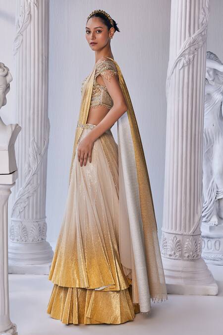 Shop_Mandira Wirk - Indian_Cream Net, Lycra Beads, Sequins, Cut Work Embroidered Corset Layered Lehenga Set _Online_at_Aza_Fashions