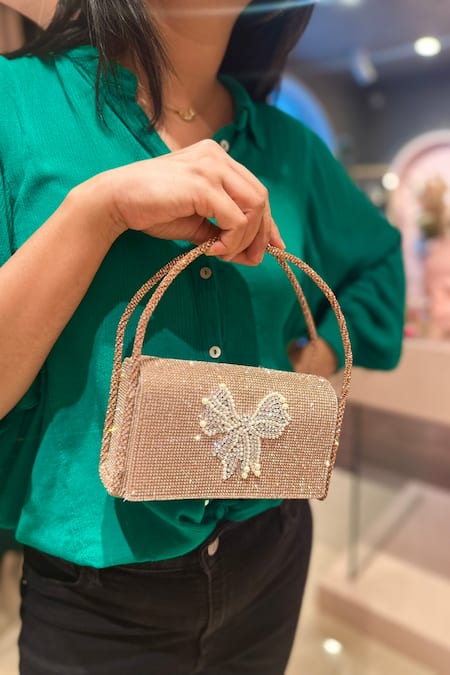 Shop Ozel Rose Gold Crystal Bow Embellished Flap Bag Shop_Ozel_Rose Gold Crystal Bow Embellished Flap Bag