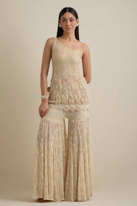 Eeksha Beige Lace, Lycra, Net Pearls, Sequins One Shoulder Embroidered Cape Sharara Set Online at Aza Fashions Eeksha_Beige Lace, Lycra, Net Pearls, Sequins One Shoulder Embroidered Cape Sharara Set _Online_at_Aza_Fashions