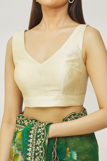 Naintara Bajaj_Gold Muslin Plunge Neck Metallic Solid Blouse _at_Aza_Fashions