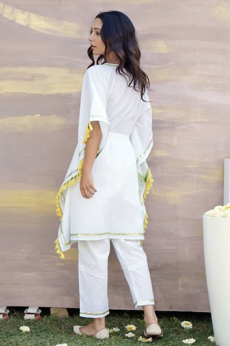 Shop Nero India Ivory Cotton Tassels V-neck Gota Lace Embellished Kaftan Tunic And Pant Set at Aza Fashions Shop_Nero India_Ivory Cotton Tassels V-neck Gota Lace Embellished Kaftan Tunic And Pant Set _at_Aza_Fashions