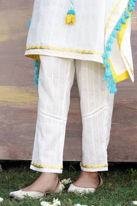 Shop Nero India Ivory Cotton Tassels, Gota Patti Lace Embellished Kaftan Tunic And Pant Set Online at Aza Fashions Shop_Nero India_Ivory Cotton Tassels, Gota Patti Lace Embellished Kaftan Tunic And Pant Set _Online_at_Aza_Fashions