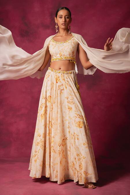 Shop Saundh Off White Crepe Crystals Round Neck Cornelia Foliage Print Cape Lehenga Set Online at Aza Fashions Shop_Saundh_Off White Crepe Crystals Round Neck Cornelia Foliage Print Cape Lehenga Set_Online_at_Aza_Fashions