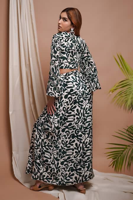 Shop Ahi Clothing White Crepe Cut Work, Mirrors, Clover Bloom Print Blouse With Draped Slit Skirt at Aza Fashions Shop_Ahi Clothing_White Crepe Cut Work, Mirrors, Clover Bloom Print Blouse With Draped Slit Skirt _at_Aza_Fashions
