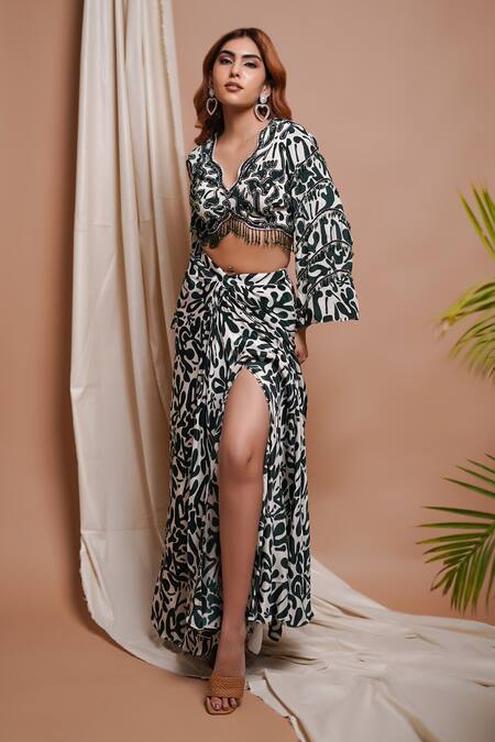 Ahi Clothing White Crepe Cut Work, Mirrors, Clover Bloom Print Blouse With Draped Slit Skirt Online at Aza Fashions Ahi Clothing_White Crepe Cut Work, Mirrors, Clover Bloom Print Blouse With Draped Slit Skirt _Online_at_Aza_Fashions