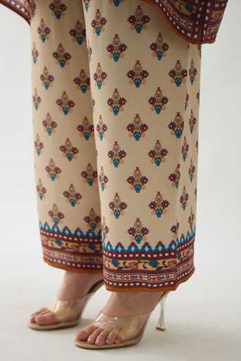 Rajdeep Ranawat_Beige Modal, Satin Permaz Bouquet Print Flared Pant _at_Aza_Fashions