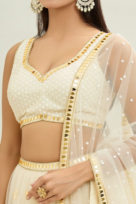 Buy_Aaryaa By Kashveen Kohli_Ivory Net Applique, Embroidery Sweetheart Neck Acrylic Lehenga Set _Online_at_Aza_Fashions