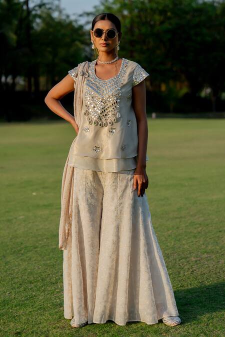 Shop_Nikita Vishakha_Gold Tissue, Jacquard Mirrors, Tassels Embroidered Peplum Top Flared Pant Set _Online_at_Aza_Fashions