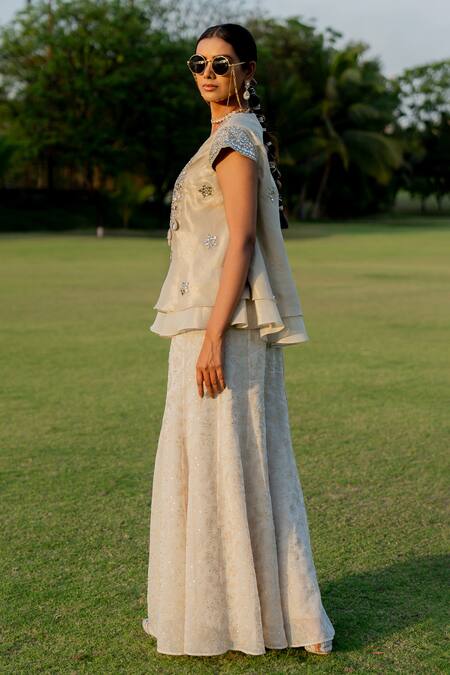 Nikita Vishakha_Gold Tissue, Jacquard Mirrors, Tassels Embroidered Peplum Top Flared Pant Set _at_Aza_Fashions