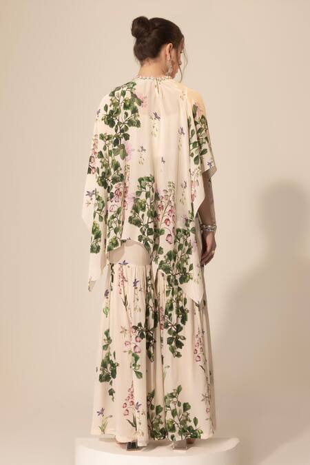 Shop SAKSHI GIRRI Ivory Crepe Sequins, Stones Botanical Print Cape And Sharara Set at Aza Fashions Shop_SAKSHI GIRRI_Ivory Crepe Sequins, Stones Botanical Print Cape And Sharara Set_at_Aza_Fashions