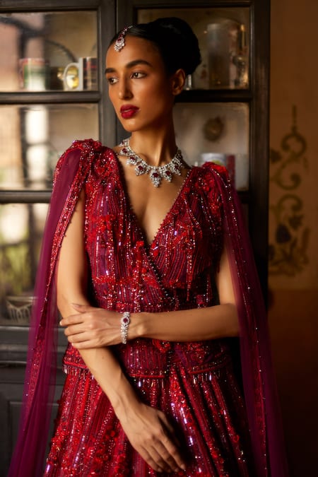 Shop Eeksha 3d Floral Swarovski Embellished Bridal Lehenga With Cape Sleeve Peplum Jacket at Aza Fashions Shop_Eeksha_3d Floral Swarovski Embellished Bridal Lehenga With Cape Sleeve Peplum Jacket _at_Aza_Fashions