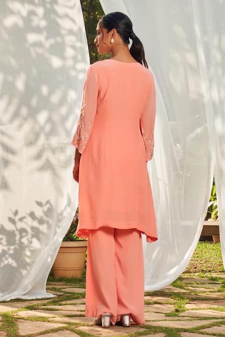 Shop Megha Pitti Peach Crepe Sequins, Cut Work Open And Cutdana Embroidered Tunic & Flared Pant Set at Aza Fashions Shop_Megha Pitti_Peach Crepe Sequins, Cut Work Open And Cutdana Embroidered Tunic & Flared Pant Set _at_Aza_Fashions