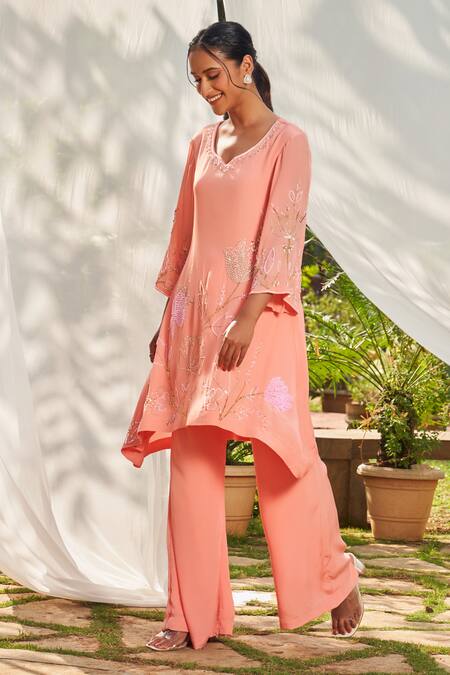 Megha Pitti Peach Crepe Sequins, Cut Work Open And Cutdana Embroidered Tunic & Flared Pant Set at Aza Fashions Megha Pitti_Peach Crepe Sequins, Cut Work Open And Cutdana Embroidered Tunic & Flared Pant Set _at_Aza_Fashions