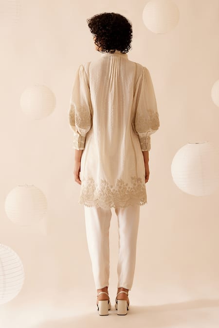Shop Bunka Ivory 100% Cotton Embellished Floral Lace Ruffle Slava Tunic at Aza Fashions Shop_Bunka_Ivory 100% Cotton Embellished Floral Lace Ruffle Slava Tunic _at_Aza_Fashions