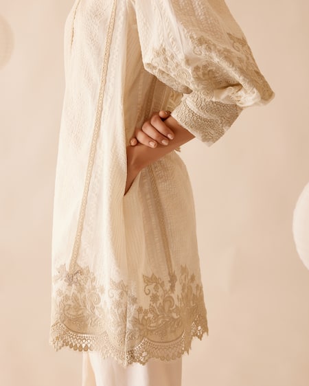Bunka Ivory 100% Cotton Embellished Floral Lace Ruffle Slava Tunic at Aza Fashions Bunka_Ivory 100% Cotton Embellished Floral Lace Ruffle Slava Tunic _at_Aza_Fashions