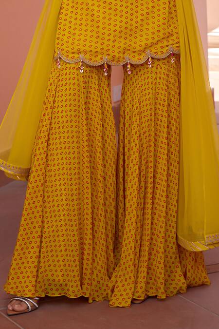 ISHA GUPTA TAYAL_Yellow Georgette, Net, Satin Sequins, Inayat Bandhani Print Kurta Sharara Set _at_Aza_Fashions