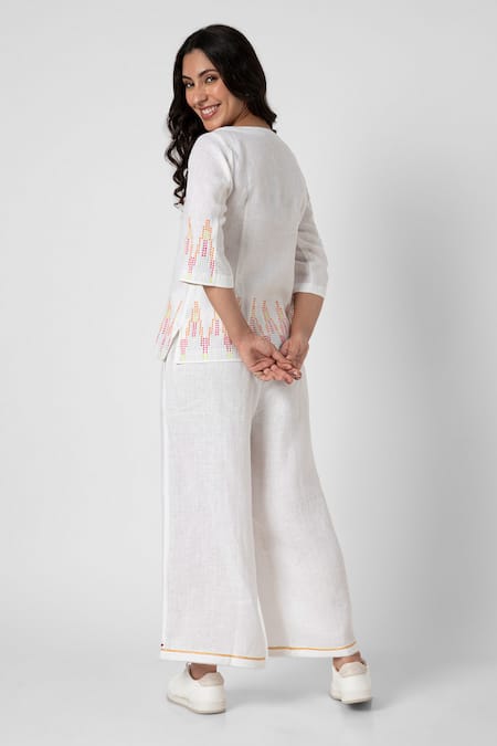 Shop Kaveri White 100% Linen Embellished Stud Boat Mona Border Top And Pant Set at Aza Fashions Shop_Kaveri_White 100% Linen Embellished Stud Boat Mona Border Top And Pant Set _at_Aza_Fashions