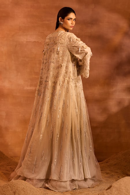 Shop Divya Aggarwal Beige Metallic Chanderi Embellished Tassel Blouse V Idalia Cape And Lehenga Set at Aza Fashions Shop_Divya Aggarwal_Beige Metallic Chanderi Embellished Tassel Blouse V Idalia Cape And Lehenga Set _at_Aza_Fashions