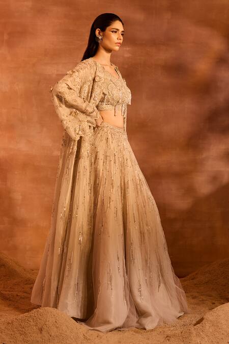 Divya Aggarwal Beige Metallic Chanderi Embellished Tassel Blouse V Idalia Cape And Lehenga Set at Aza Fashions Divya Aggarwal_Beige Metallic Chanderi Embellished Tassel Blouse V Idalia Cape And Lehenga Set _at_Aza_Fashions