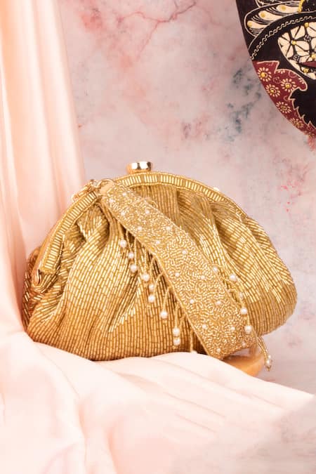 Shop Nayaab By Sonia Gold Cut Work, Pearls Chique Stripe Embellished Potli at Aza Fashions Shop_Nayaab By Sonia_Gold Cut Work, Pearls Chique Stripe Embellished Potli _at_Aza_Fashions