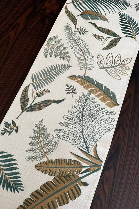 Shop House Of Inari Beige 100% Cotton Thread, Tassels, Palm Leaves And Embroidered Table Runner at Aza Fashions Shop_House Of Inari_Beige 100% Cotton Thread, Tassels, Palm Leaves And Embroidered Table Runner_at_Aza_Fashions
