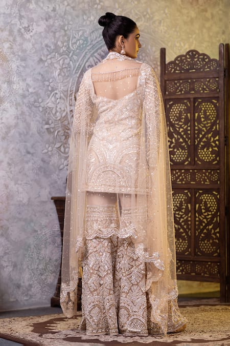 Shop_Raj Arora_Cream Net Sequins, Zari, Cut Work V-neck Embroidered Short Kurta Gharara Set _at_Aza_Fashions